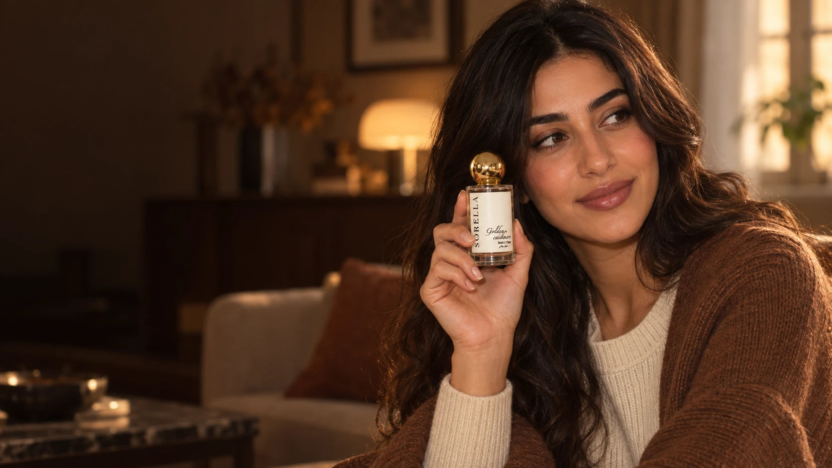 Golden Cashmere campaign: a model holding the Sorella bottle in a warm autumn setting